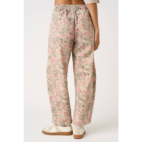 Floral patterned pants worn by a person on a white background