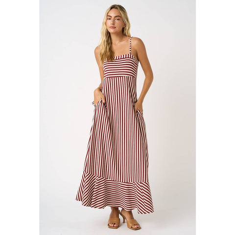 Woman wearing a red and white striped dress on a white background