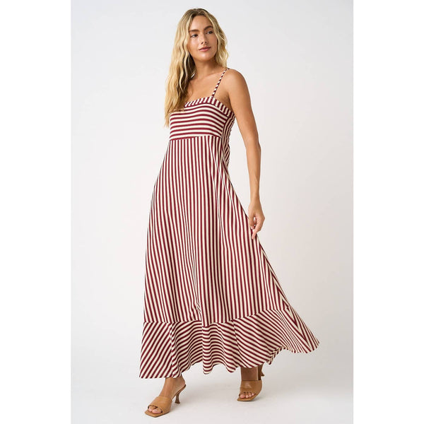 Woman wearing a wine and white striped dress on a white background