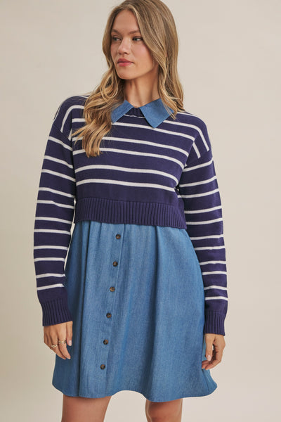 A woman modeling a two-piece knit and denim outfit featuring a navy and white striped long-sleeve top with a blue collar, paired with a blue denim button-front skirt, against a solid beige background.
