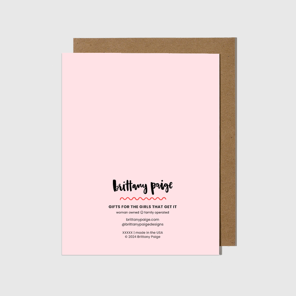 Pink card with brown envelope on a light gray background