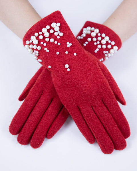 Red gloves with pearl embellishments on a white background