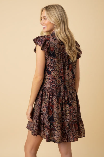 Woman wearing paisley flowy dress.