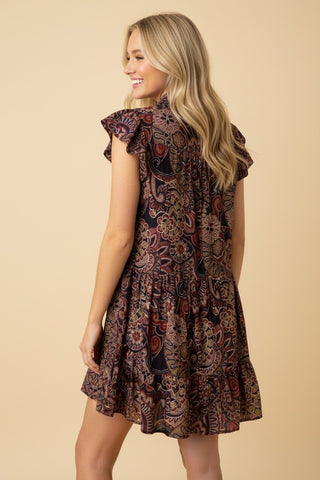 Woman wearing paisley flowy dress.