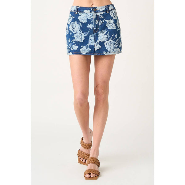 Person wearing a blue floral skirt on a white background