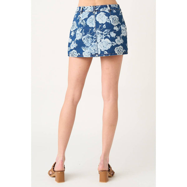 Blue floral denim skirt worn by a person on a white background