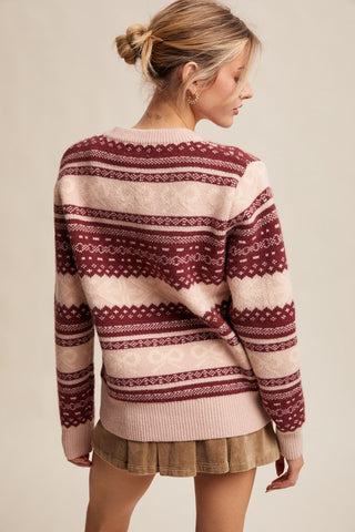 Woman wearing a patterned sweater with a neutral background