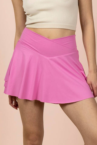 Person wearing a pink skirt on a beige background