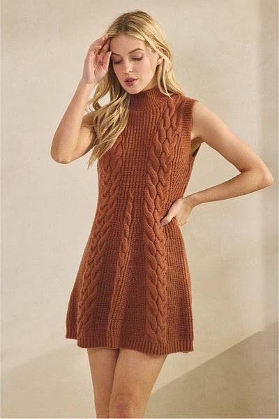 Woman wearing a brown knitted dress against a beige background