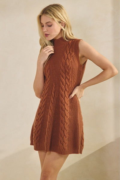 Woman wearing a brown knitted dress against a beige background