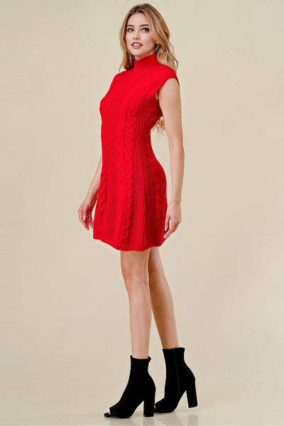 Woman wearing a red dress with black boots on a beige background