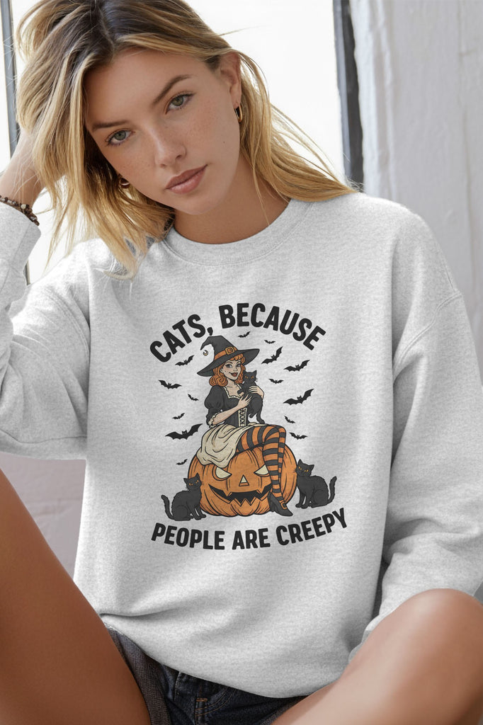Person wearing a gray sweatshirt with Halloween-themed design and text.