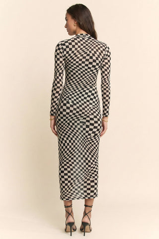 Woman wearing a black and white checkered dress against a beige background