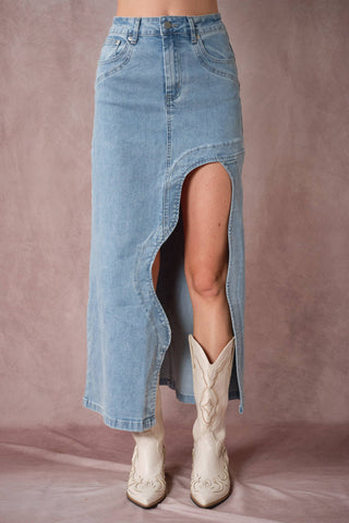 Denim skirt with a high slit worn by a person on a plain background