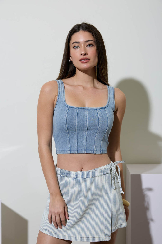 Woman wearing a light blue washed knit cropped tank with square neckline and front seam detailing, styled for a casual summer outfit.