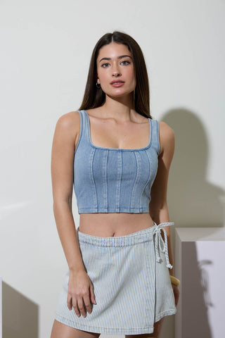 Woman wearing a light blue washed knit cropped tank with square neckline and front seam detailing, styled for a casual summer outfit.