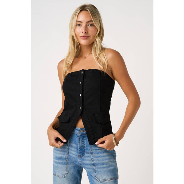 Woman wearing a black strapless top and blue jeans on a white background
