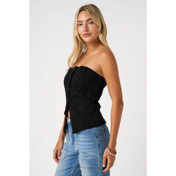 Woman wearing a black strapless top and blue jeans on a white background