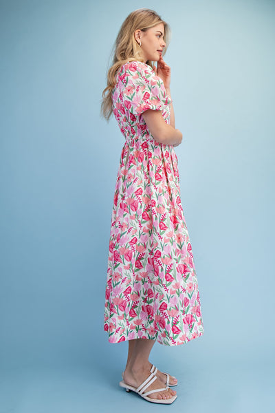 Woman wearing a floral dress against a blue background