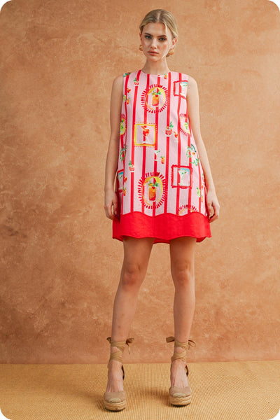 Woman wearing a red sleeveless dress with colorful patterns against a brown background