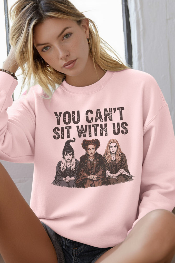 Pink Hocus Pocus Halloween sweatshirt featuring the Sanderson Sisters and You Can’t Sit With Us graphic.
