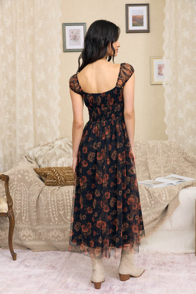 Women’s black floral organza midi dress with rust rose print, sweetheart neckline, sheer short sleeves and shirred waist.