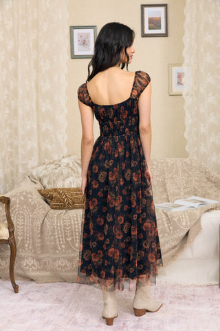 Women’s black floral organza midi dress with rust rose print, sweetheart neckline, sheer short sleeves and shirred waist.