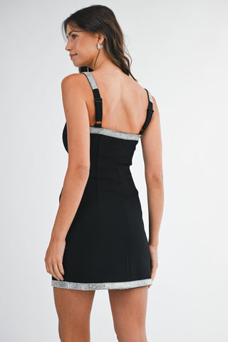 Black dress with silver trim on a white background