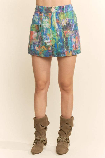 Multicolored patterned skirt worn by a person on a beige background