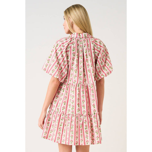 Woman wearing a pink floral dress on a white background