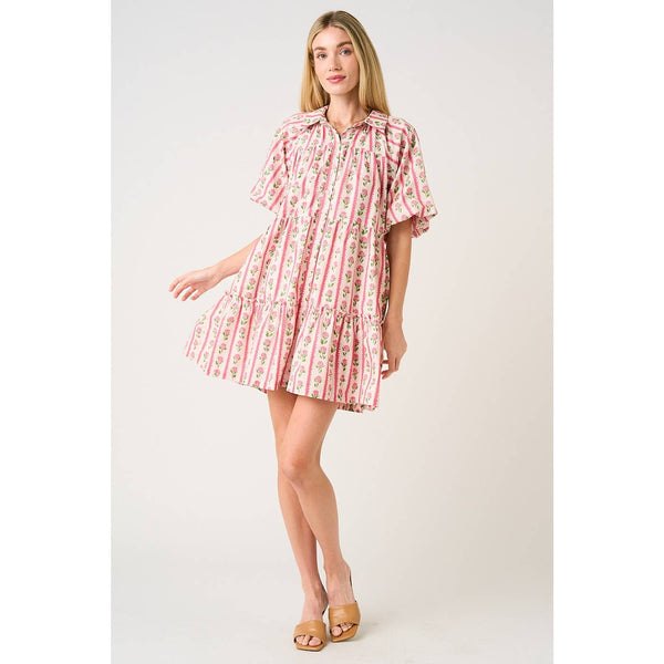 Woman wearing a pink floral dress on a white background