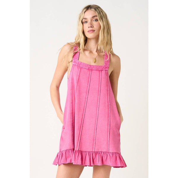 Woman wearing a pink dress against a white background