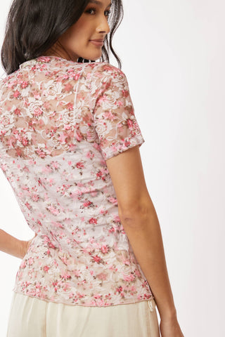 Woman wearing a floral blouse with a plain background