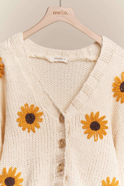 Knitted cardigan with sunflower patterns on a hanger