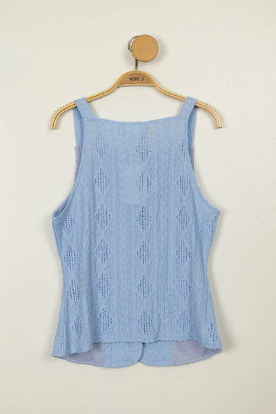 Light blue sleeveless top on a hanger against a beige background
