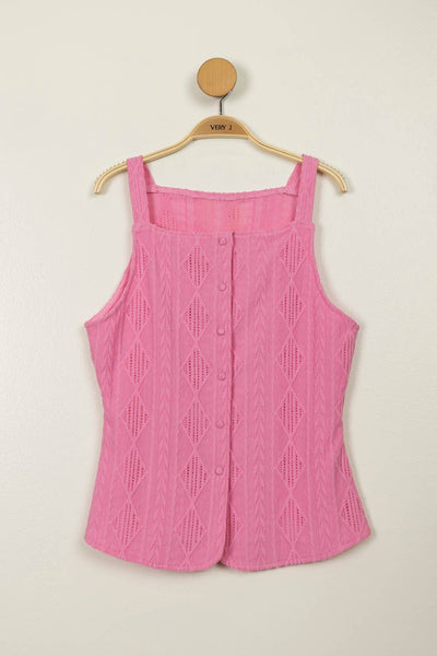 Pink knitted vest on a hanger against a beige background