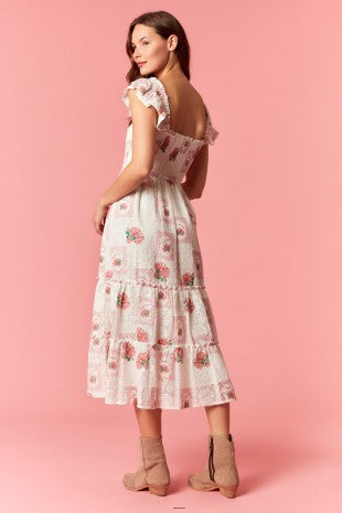 Woman wearing a floral dress on a pink background