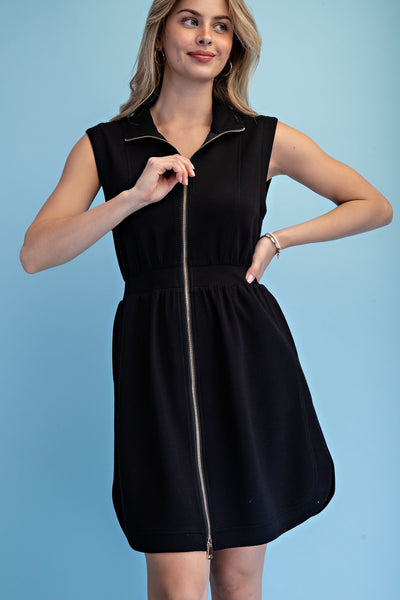 Woman wearing a black sleeveless dress with a zipper on a blue background